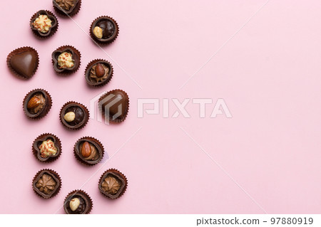 Different kinds of chocolates on colored table close-up. Top View and Flat Lay with copy space Different kinds of chocolates on colored table close-up. Top View and Flat Lay with copy space 97880919