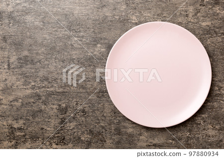 Top view of empty pink plate on cement background. Empty space for your design 97880934