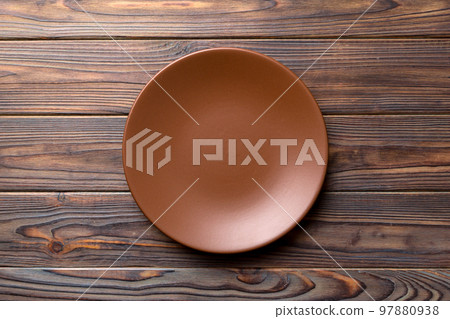Top view of empty plate on wooden background. Empty space for your design 97880938
