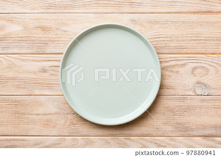 Top view of empty blue plate on wooden background. Empty space for your design 97880941