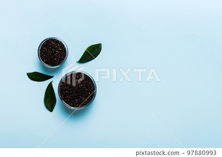 quinoa seeds in bowl on colored background. Healthy kinwa in small bowl. Healthy superfood 97880993