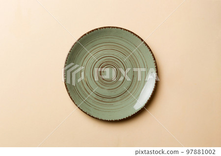 Top view of isolated of colored background empty round green plate for food. Empty dish with space for your design 97881002