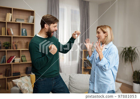 Happy Couple Holding Key. Happy Young Family Holding Key and Rejoicing 97881053