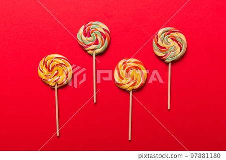 Set of colorful lollipops on colored background. Summer concept. Party Happy Birthday or Minimalist Concept Set of colorful lollipops on colored background. Summer concept. Party Happy Birthday or Minimalist Concept 97881180