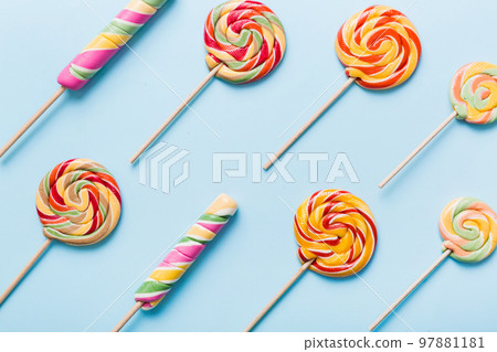 Set of colorful lollipops on colored background. Summer concept. Party Happy Birthday or Minimalist Concept Set of colorful lollipops on colored background. Summer concept. Party Happy Birthday or Minimalist Concept 97881181