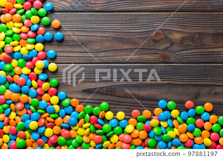 Mixed collection of colorful candy, on colored background. Flat lay, top view. frame of colorful chocolate coated candy Mixed collection of colorful candy, on colored background. Flat lay, top view. frame of colorful chocolate coated candy 97881197