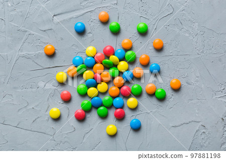 Mixed collection of colorful candy, on colored background. Flat lay, top view. frame of colorful chocolate coated candy Mixed collection of colorful candy, on colored background. Flat lay, top view. frame of colorful chocolate coated candy 97881198