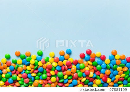 Mixed collection of colorful candy, on colored background. Flat lay, top view. frame of colorful chocolate coated candy Mixed collection of colorful candy, on colored background. Flat lay, top view. frame of colorful chocolate coated candy 97881199