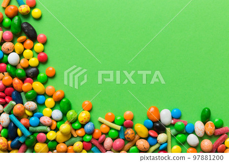 Mixed collection of colorful candy, on colored background. Flat lay, top view. frame of colorful chocolate coated candy 97881200