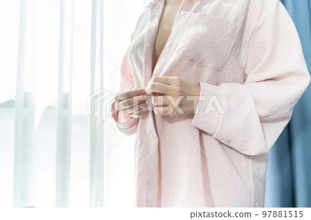 Beautiful and sexy Asian Breast in front of hotel curtain light inside pastel pink t-shirt. Beautiful and sexy Asian Breast in front of hotel curtain light inside pastel pink t-shirt. 97881515
