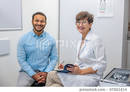 Female optometrist working with a male patient Female optometrist working with a male patient 97881814