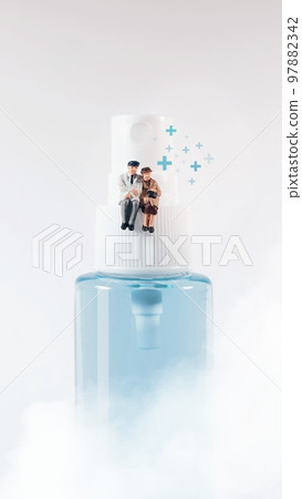 Elderly couple figure sitting on a  alcohol spray bottle. Covid-19 concept. 97882342