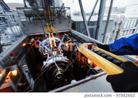 Yellow Remote control of a crane for installing a gas turbine plant for generating energy Yellow Remote control of a crane for installing a gas turbine plant for generating energy 97882602