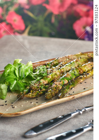 Grilled asparagus with peanut sauce on a plate. selective focus 97883124