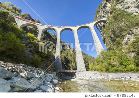 Swiss train over Landwasser Viaduct bridge in the alps, Graubunden, Switzerland 97883143