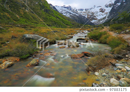 Melting frozen river, Andes landscape in Tierra Del fuego, Ushuaia, Argentina Melting frozen river, Andes landscape in Tierra Del fuego, Ushuaia, Argentina 97883175