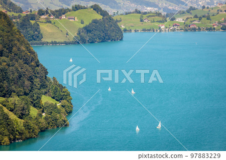 Turquoise Lungernsee and village lungern in the Swiss Alps, Switzerland Turquoise Lungernsee and village lungern in the Swiss Alps, Switzerland 97883229