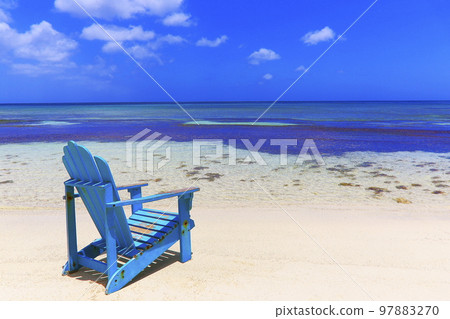 Colorful wooden chairs on white sand beach in Aruba, Duth Caribbean 97883270