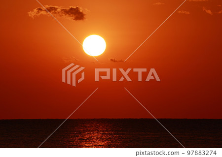 sun setting into the sea 97883274