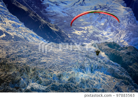 Paragliding above Mont Blanc massif alpine landscape , Chamonix, French Alps Paragliding above Mont Blanc massif alpine landscape , Chamonix, French Alps 97883563