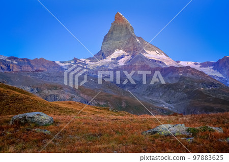 Matterhorn above zermatt idyllic valley at sunrise, Swiss Alps 97883625