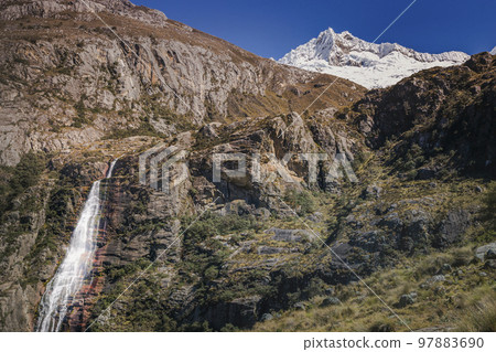 Waterfall and Huascaran massif in Cordillera Blanca, snowcapped Andes, Ancash, Peru 97883690
