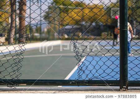 Hole in the fence. Mesh wire boundary. Steel mesh barrier fence. Hole in the fence. Mesh wire boundary. Steel mesh barrier fence. 97883805