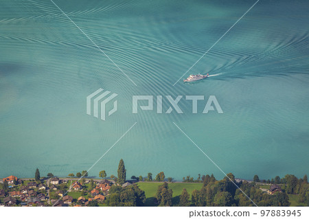 Aerial view of Swiss Alps and Lake Brienz with ferry boat at sunset, Interlaken 97883945