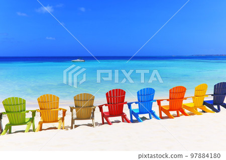 Colorful wooden chairs on white sand beach in Aruba, Duth Caribbean 97884180