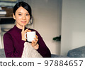 Woman relaxing in the living room 97884657
