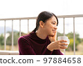 Woman relaxing on the terrace 97884658