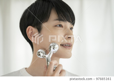 Young man skin care beauty image facial roller 97885161
