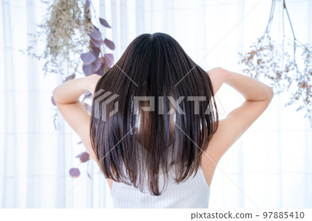 Rear view of a woman wearing a tank top 97885410
