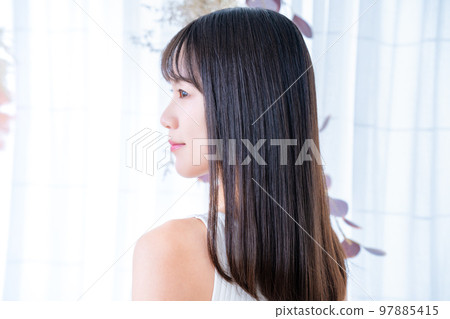 Rear view of a woman wearing a tank top 97885415