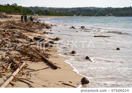 Mountains of waste and garbage on the sandy beach after the tide. Humanity is polluting the ocean Mountains of waste and garbage on the sandy beach after the tide. Humanity is polluting the ocean 97886024