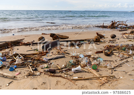 Mountains of waste and garbage on the sandy beach after the tide. Humanity is polluting the ocean Mountains of waste and garbage on the sandy beach after the tide. Humanity is polluting the ocean 97886025
