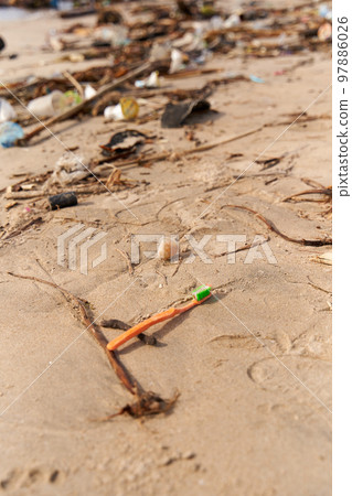 Mountains of waste and garbage on the sandy beach after the tide. Humanity is polluting the ocean Mountains of waste and garbage on the sandy beach after the tide. Humanity is polluting the ocean 97886026