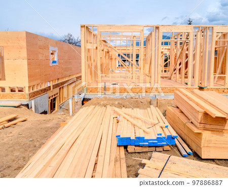 Wooden frame of new building with engineered lumber materials in front 97886887