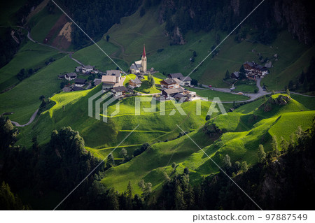 Romantic small village with chapel in the South Tyrolean Alps in Italy 97887549