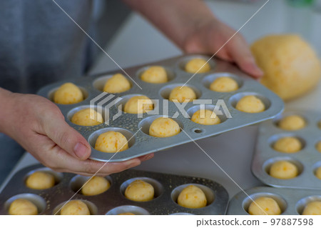 Brazilian traditional cheese buns are homemade snacks that are prepared and baked home Brazilian traditional cheese buns are homemade snacks that are prepared and baked home 97887598