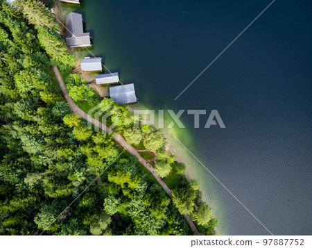 Fir trees and a lake from above - top down view Fir trees and a lake from above - top down view 97887752