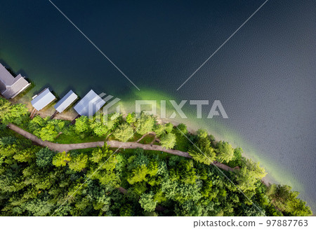 Fir trees and a lake from above - top down view Fir trees and a lake from above - top down view 97887763