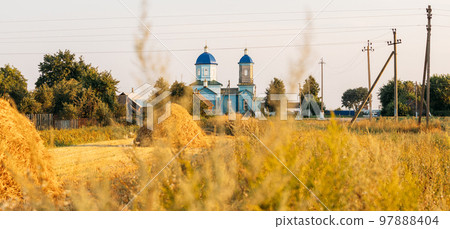 Old wooden orthodox church of the nativity of the Most Holy Theotokos in sunny summer evening. Countryside landscape. Architectural monument. Glybotskoye, Gomel Region, Belarus. Panorama, panoramic 97888404