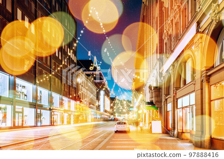 Helsinki, Finland. Effect Bokeh Night View Of Aleksanterinkatu Street With Railroad In Kluuvi District In Evening Christmas Xmas New Year Festive Illumination Boke Blured View Helsinki, Finland. Effect Bokeh Night View Of Aleksanterinkatu Street With Railroad In Kluuvi District In Evening Christmas Xmas New Year Festive Illumination Boke Blured View 97888416