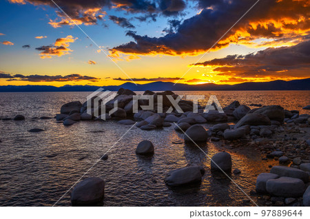 Sunset above rocky beach of Lake Tahoe in California Sunset above rocky beach of Lake Tahoe in California 97889644