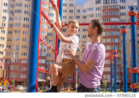Cute baby and daddy play on the playground Cute baby and daddy play on the playground 97890118