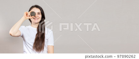 A woman with long hair holds a solid shampoo. Ecology cosmetics with natural composition. Plant shampoo, environmental theme. Banner place for text. 97890262