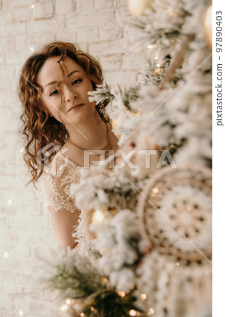 A young beautiful girl in a New Year's interior. 97890403
