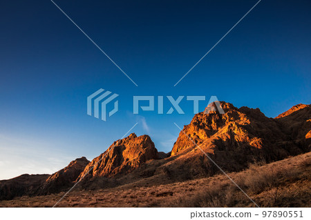 Sunrise rocky picturesque landscape near the Ili River in the Almaty region of Kazakhstan 97890551