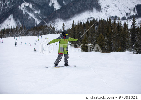 man snowboarder portrait on ski slope man snowboarder portrait on ski slope 97891021